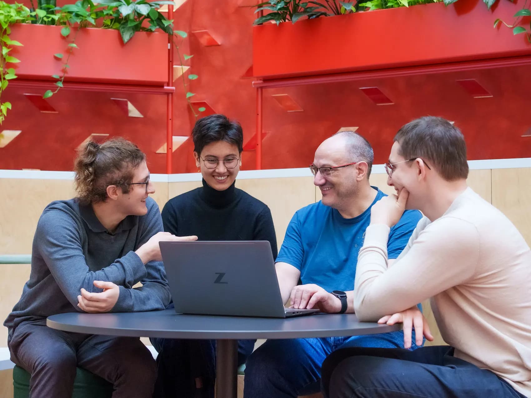 A collaborative workspace at TrustID where professionals exchange ideas in a friendly and innovative environment