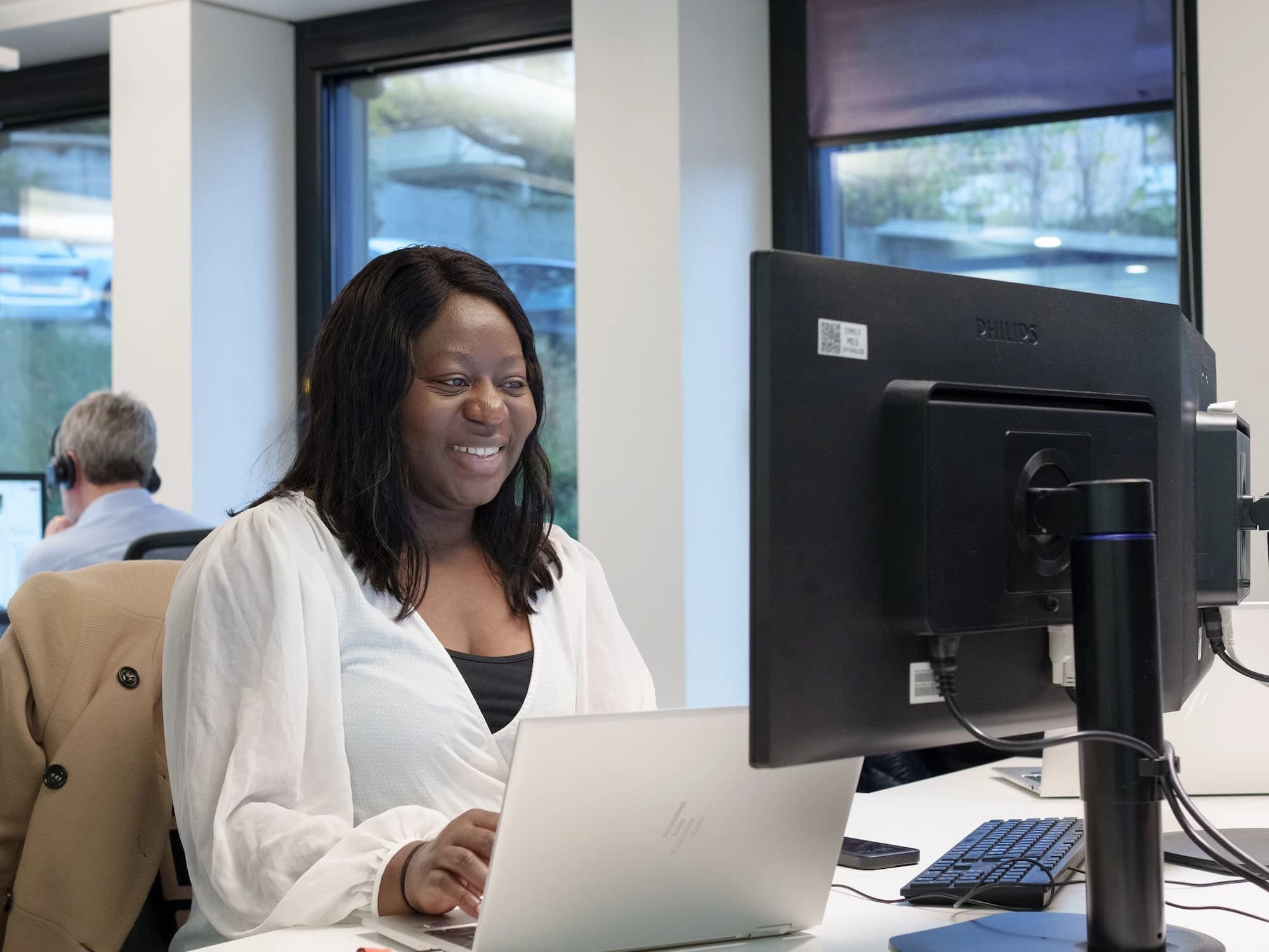 TrustID professionals analyzing data on a laptop, collaborating on technological solutions in a dynamic workspace